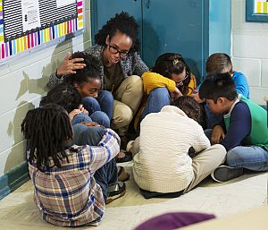 teacher shielding children school violence